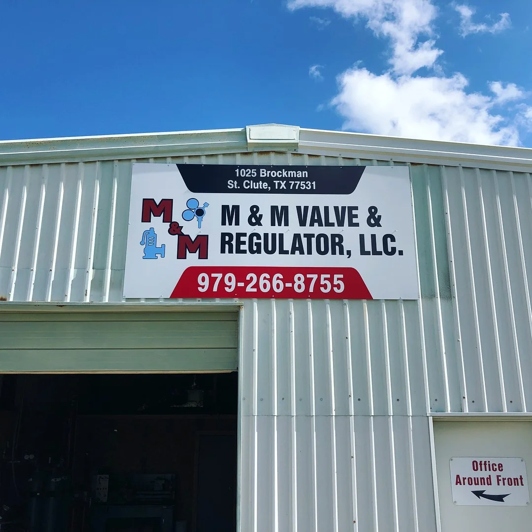 M&M Valve & Regulator heavy-duty exterior aluminum industrial facility building sign mounted on metal facade